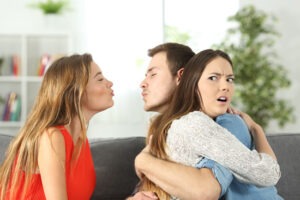 A male and female person involved in a secret affair behind his partners back.