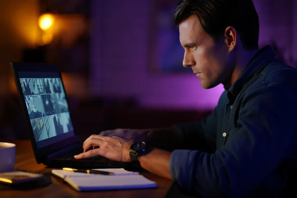 Investigator Reviewing Footage on Laptop